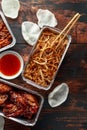 Chinese takeaway food. Crispy shredded beef, sweet and sour chicken wings, egg noodles with bean sprouts, pineapple Royalty Free Stock Photo
