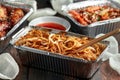 Chinese takeaway food. egg noodles with bean sprouts, chilli dip and prawn crackers Royalty Free Stock Photo