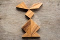 Chinese tangram puzzle in rabbit shape on wood background Con Royalty Free Stock Photo