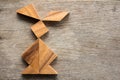 Chinese tangram puzzle in rabbit shape on wooden background Con Royalty Free Stock Photo