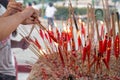 Chinese taoist devotee lighting up candles at temple