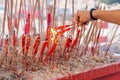 Chinese taoist devotee lighting up candles at temple