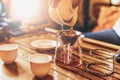 Chinese tea ceremony, girl pours pu-er from gaiwan through strainer in chahai, selective focus