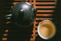 Chinese tea ceremony. Top view tea set: teapot and a cup of green puer tea on wooden table. Asian traditional culture.