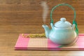 Chinese tea pot on pink bamboo mat still life style