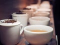 Chinese tea in white tea pot and cups with the black tea leaves Royalty Free Stock Photo