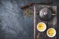 Chinese teapot and bowl with green tea on the stone background top view Royalty Free Stock Photo