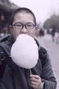 Chinese teen boy eating marshmallow