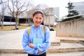 Chinese teenager smiling happy at university campus. Close up portrait of cheerful Asian girl looking at