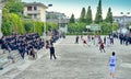 Chinese teenagers playing a basketball game in the high school.