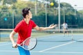 Chinese tennis player ready to hit the ball while serving in a tennis match Royalty Free Stock Photo