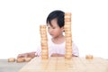 Chinese three-year-old child stacks Chinese chess pieces high on the chessboard Royalty Free Stock Photo