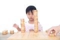 Chinese three-year-old child stacks Chinese chess pieces high on the chessboard Royalty Free Stock Photo