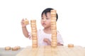 Chinese three-year-old child stacks Chinese chess pieces high on the chessboard Royalty Free Stock Photo