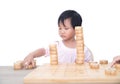 Chinese three-year-old child stacks Chinese chess pieces high on the chessboard Royalty Free Stock Photo