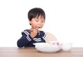 Chinese three-year-old girl eating on white