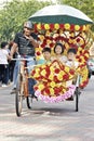 Chinese tourist kids having a sustainable and colorful trishaw ride in malacca Royalty Free Stock Photo