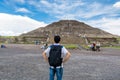 A Chinese tourist looking at the largest ruins of the architecturally significant Mesoamerican pyramids in Teotihuacan, an