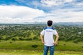 A Chinese tourist standing on the top of the largest ruins of the architecturally significant Mesoamerican pyramids in