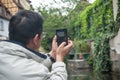 Chinese tourist taking a picture in Boat at little Venise quarter