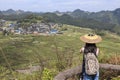 Chinese Tourist watching the Gaoyao Rice terraces in Guizhou from a viewpoint