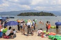 Chinese tourists on a beach of the Fuxian Lake in Yunnan, the thid deepest lake in China. It is located halfwy between the capital Royalty Free Stock Photo