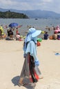 Chinese tourists on a beach of the Fuxian Lake in Yunnan, the thid deepest lake in China. It is located halfwy between the capital Royalty Free Stock Photo