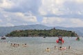 Chinese tourists on a beach of the Fuxian Lake in Yunnan, the thid deepest lake in China. It is located halfwy between the capital