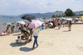 Chinese tourists on a beach of the Fuxian Lake in Yunnan, the thid deepest lake in China. It is located halfwy between the capital Royalty Free Stock Photo