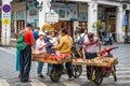 Chinese tourists buying exotic fruits from local peoples hawking in the street of Haikou old town Hainan China