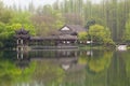 Chinese traditional bridge with pavilion on the coast of West Lake, public park in Hangzhou city, China Royalty Free Stock Photo