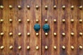 Chinese traditional doorknob and wooden doors. Old handle of metal on a wooden old door. Door knocker in the shape of a Royalty Free Stock Photo