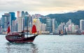 Chinese traditional junk boat in front of Hong Kong skyline Royalty Free Stock Photo