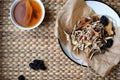 Chinese traditional medicine script. Herbal tea with jujubes, goji berries, gingseng roots and others on parchment paper on neutra