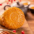 Chinese traditional pastry Moon cake Mooncake with tea cups on bamboo serving tray on wooden background for Mid-Autumn Festival, Royalty Free Stock Photo