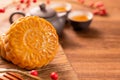 Chinese traditional pastry Moon cake Mooncake with tea cups on bamboo serving tray on wooden background for Mid-Autumn Festival, Royalty Free Stock Photo