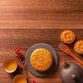 Chinese traditional pastry Moon cake Mooncake with tea cups on bamboo serving tray on wooden background for Mid-Autumn Festival, Royalty Free Stock Photo