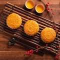 Chinese traditional pastry Moon cake Mooncake with tea cups on bamboo serving tray on wooden background for Mid-Autumn Festival, Royalty Free Stock Photo