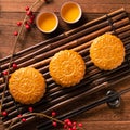 Chinese traditional pastry Moon cake Mooncake with tea cups on bamboo serving tray on wooden background for Mid-Autumn Festival, Royalty Free Stock Photo