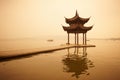 Chinese traditional wooden gazebo on the coast of West Lake, public park in Hangzhou city, China Royalty Free Stock Photo