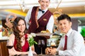 Chinese waiter serving dinner in elegant restaurant or Hotel Royalty Free Stock Photo