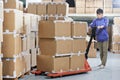 Chinese warehouse worker with forklift stacker