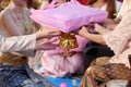 Chinese wedding tea ceremony. Bride and groom giving gift to elder. Selective focus and shallow depth of field.