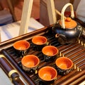 Chinese white teapot and teacups on the wooden trivet Royalty Free Stock Photo