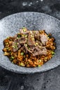 Chinese wok fried rice with vegetables and beef. Black background. Top view Royalty Free Stock Photo
