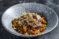 Chinese wok fried rice with vegetables and beef. Black background. Top view Royalty Free Stock Photo