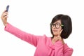 Asian woman using a cell phone to take a selfie isolated on white background Royalty Free Stock Photo