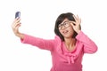 Asian woman using a cell phone to take a selfie isolated on white background Royalty Free Stock Photo