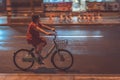 Chinese woman on a bicycle at night