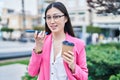 Chinese woman business worker talking on smartphone drinking coffee at park Royalty Free Stock Photo